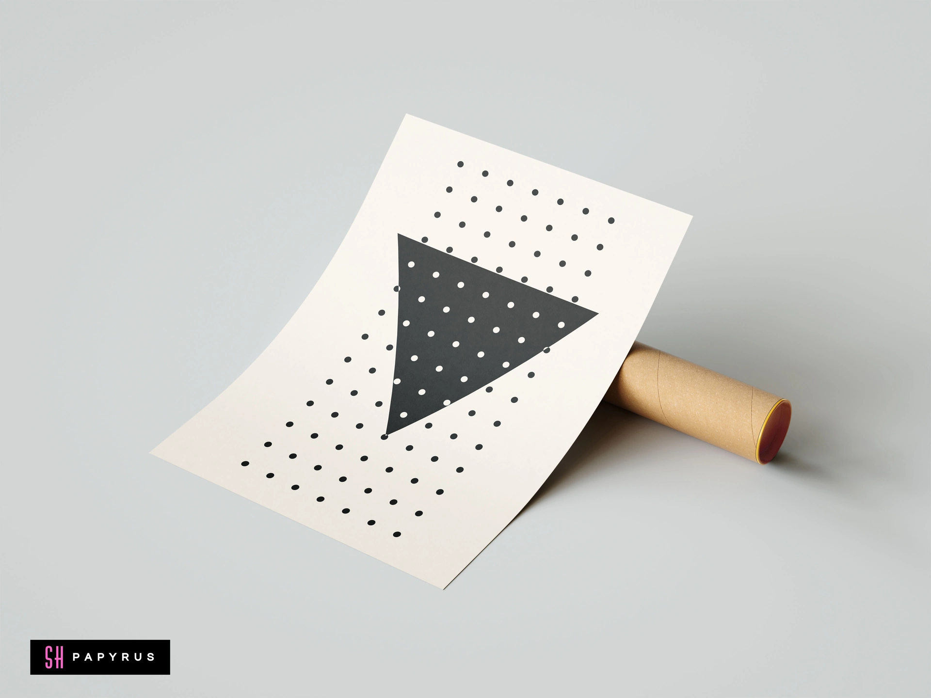 Modern minimalist wall art featuring a bold black triangle and geometric polka dot pattern on a cream background, shown propped against a mailing tube.