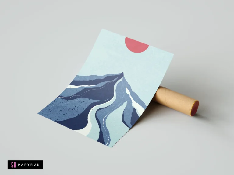 Modern abstract art print featuring layered blue mountain peaks and a vibrant red sun, shown resting against a cardboard shipping tube.