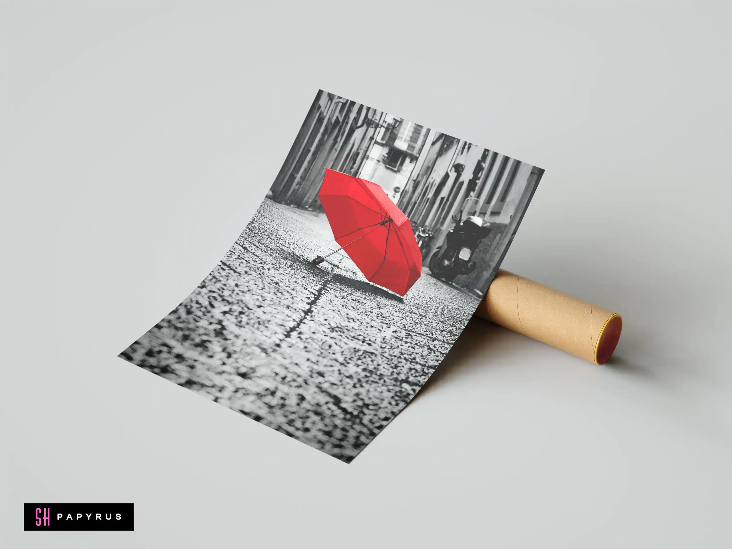 Vibrant red umbrella on a black and white cobblestone city street artistic selective color.
