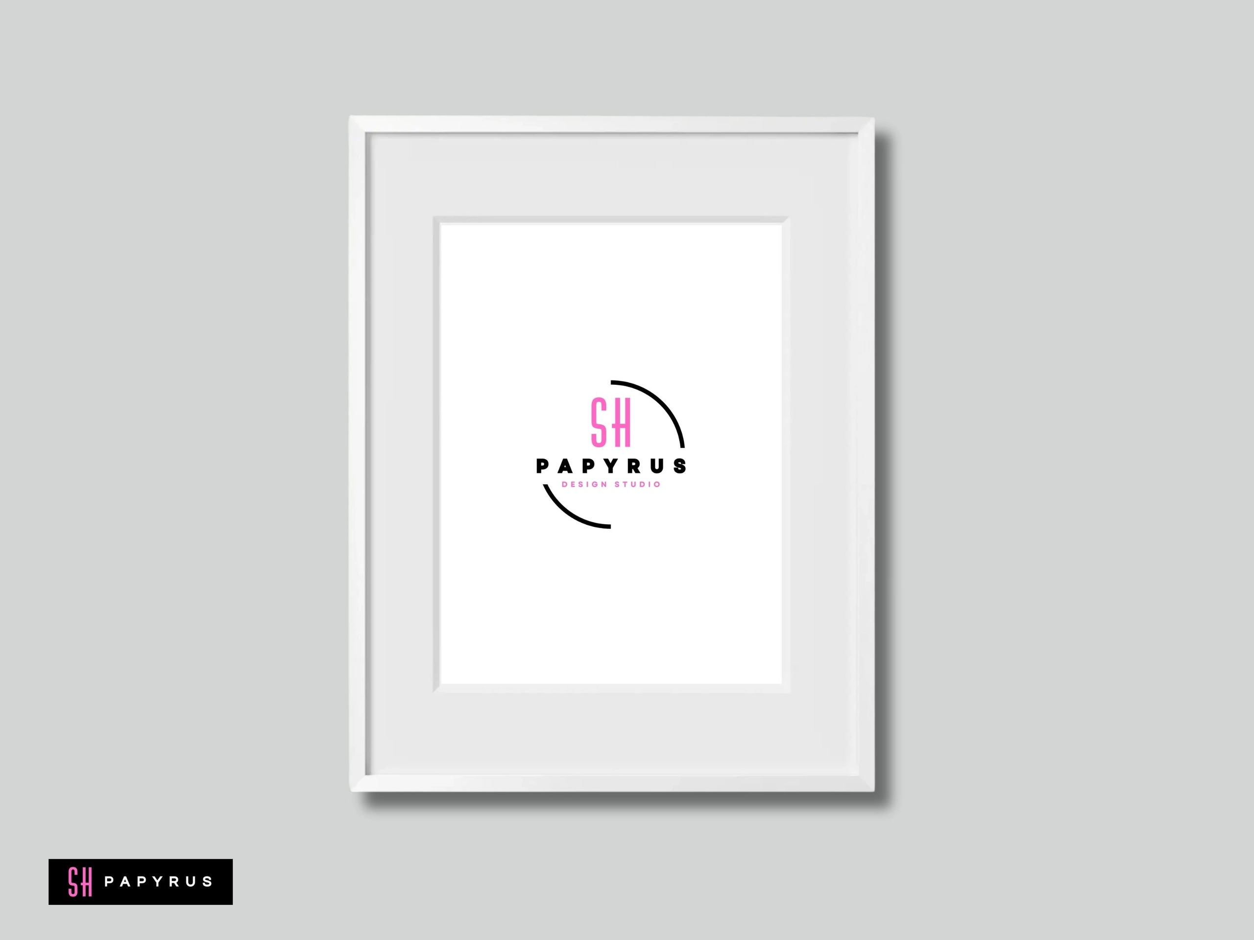 White framed wall art featuring minimalist pink and black design studio logo on grey background.