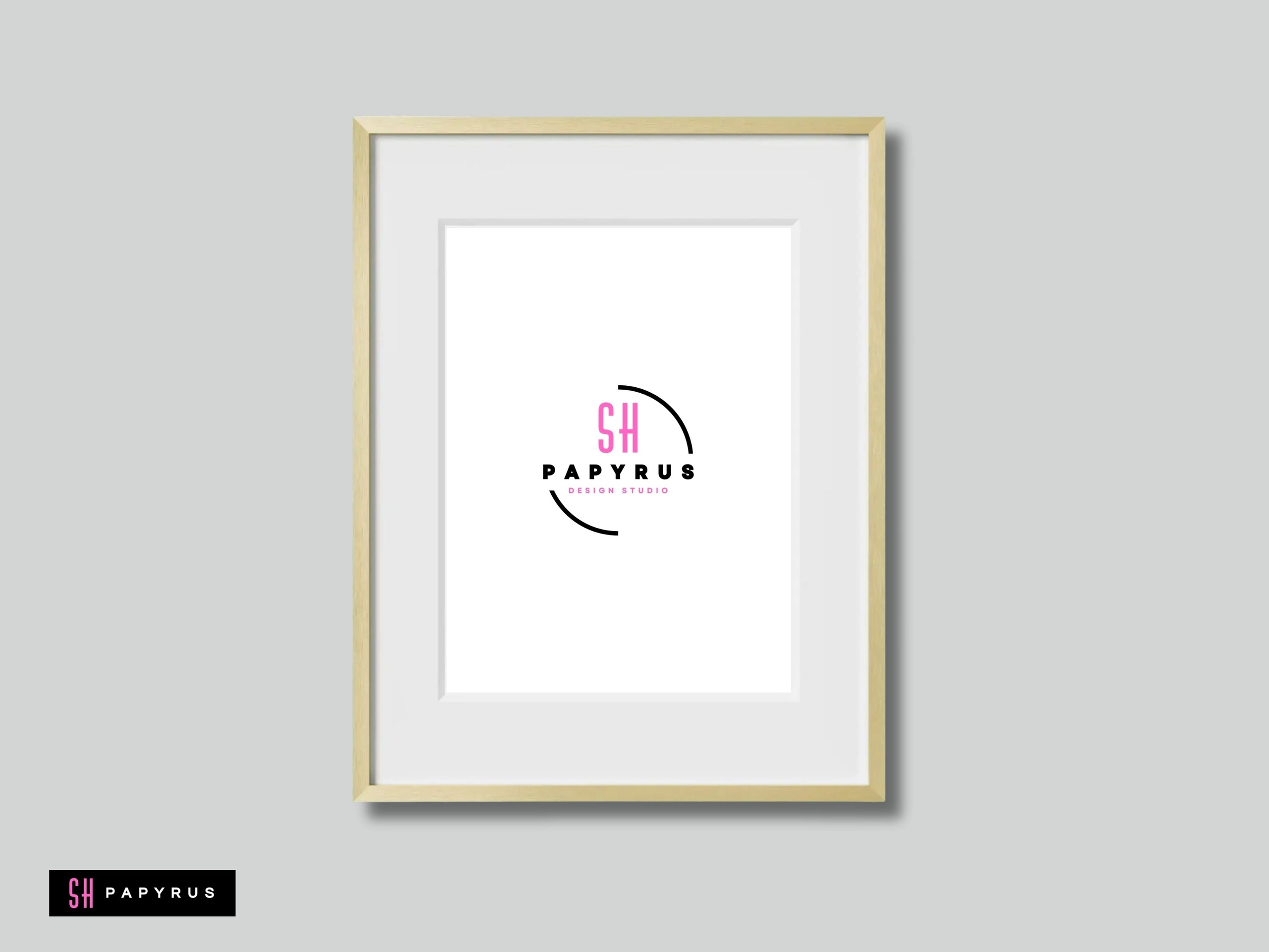 Elegant gold framed wall art displaying a modern pink and black logo on white.