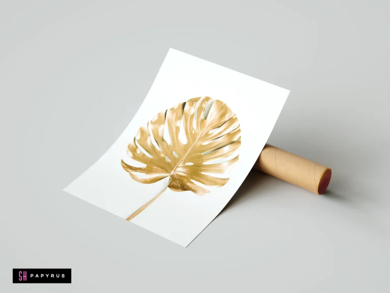 Minimalist tropical art print featuring a metallic gold monstera leaf on a white background.