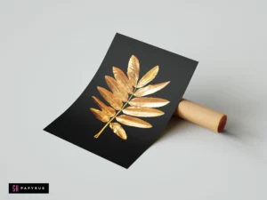 Minimalist black wall art featuring a detailed metallic gold rowan leaf branch.