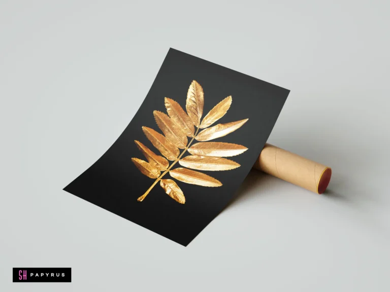 Minimalist black wall art featuring a detailed metallic gold rowan leaf branch.