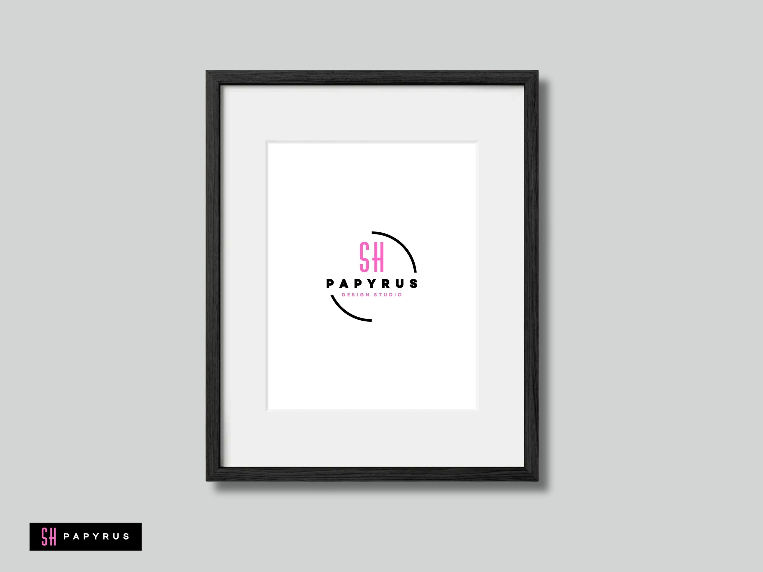 Modern black framed wall art showcasing a minimalist pink and black graphic studio logo.